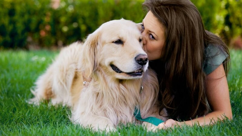 Woman kissing her Dog