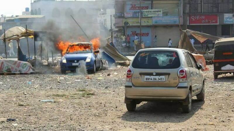 A car burning in the riot of koregaon