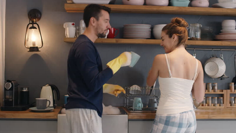 Couple doing the dishes together and splitting work