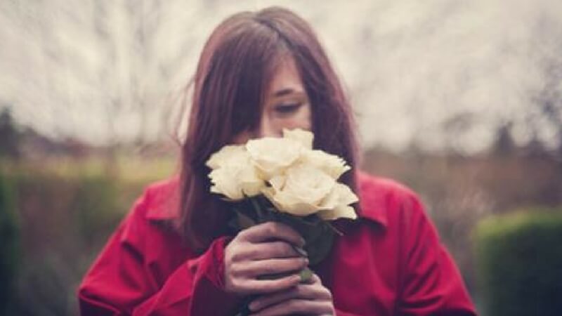 A girl smelling flowers Disney