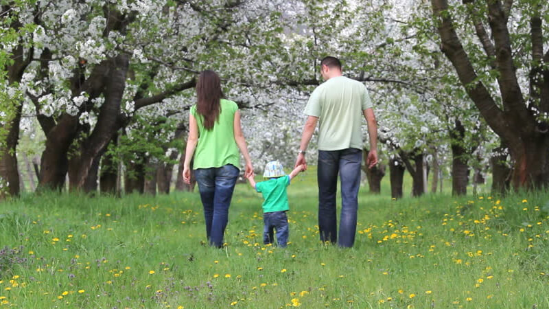 Couple walking together with their kid