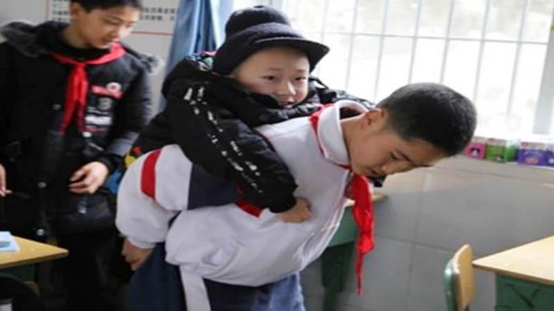 Boy Carries Disabled Friend To School