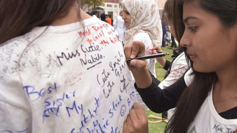 Girls writing on tshirt