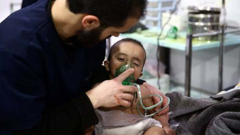Man with a child are seen in hospital in the besieged town of Douma, Eastern