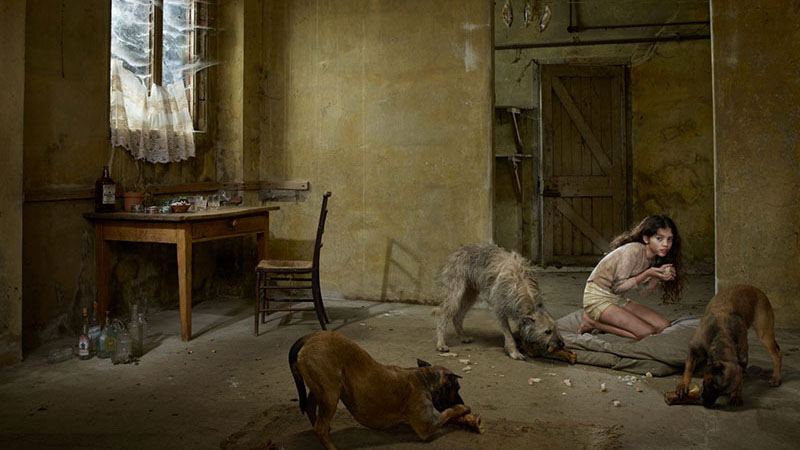 Medina, a small Russian child, living with dogs in 2013