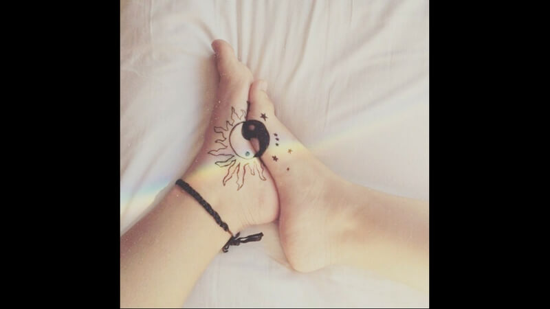 Ying-yang foot tattoo