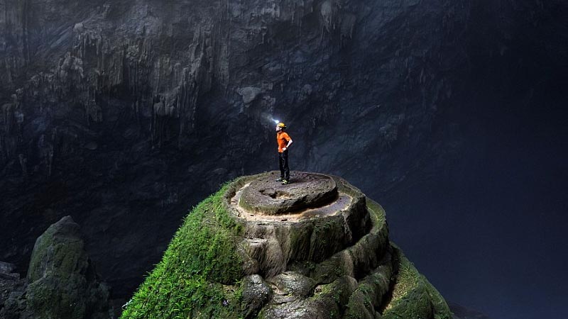 An explorer looks round at the spectacular cave, which takes a half day's trek to