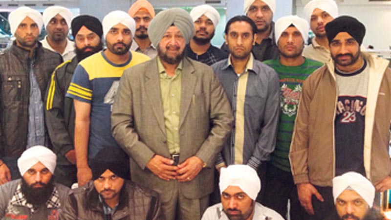 FREEDOM AT LAST: The youths with businessman SPS Oberoi (C) at Dubai airport shortly before their flight on Monday night.